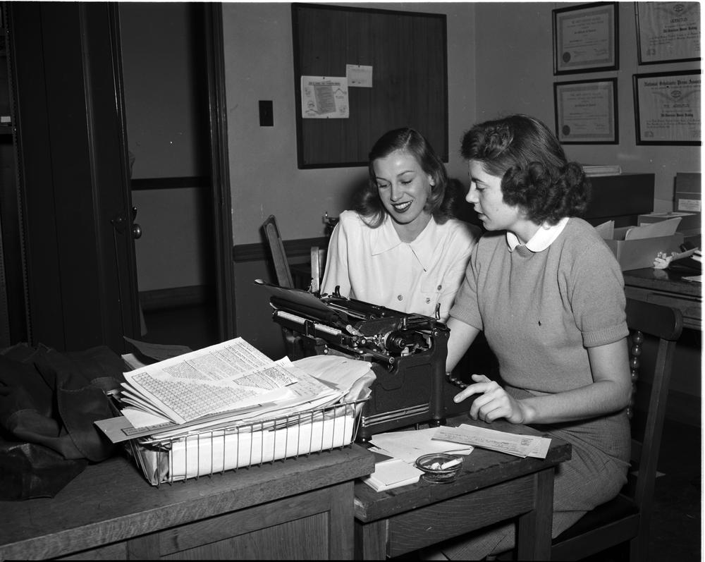 Black and white photo of IU office staff stting at a typewriter