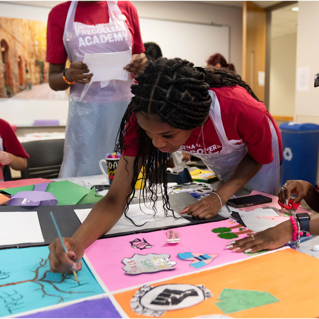 Student writing at Precollege Program activity